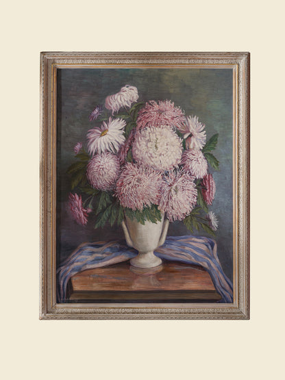 Oil painting titled Blush Chrysanthemums in White Vase, featuring a lush bouquet of pink chrysanthemums arranged in a classic white vase with a striped blue cloth.