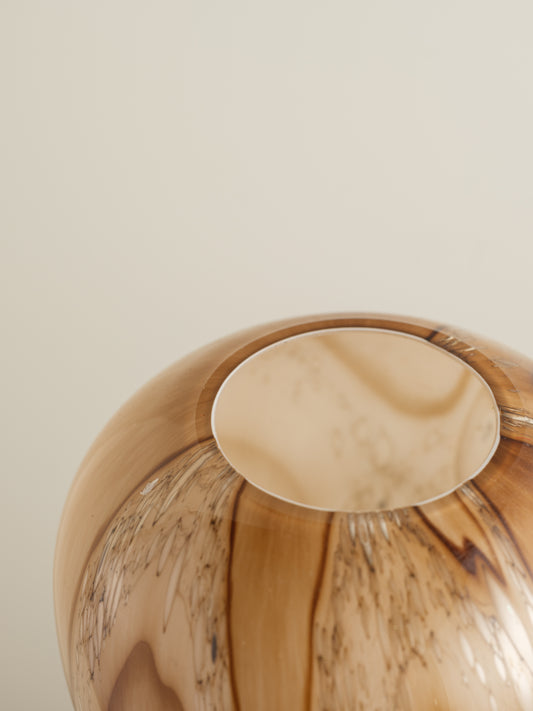Tall fluted glass vase with caramel and brown marbled driftwood pattern.