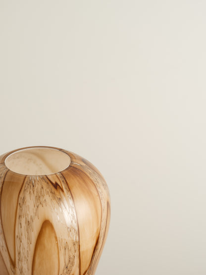 Tall fluted glass vase with caramel and brown marbled driftwood pattern.