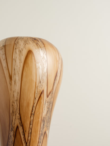 Tall fluted glass vase with caramel and brown marbled driftwood pattern.