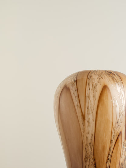 Tall fluted glass vase with caramel and brown marbled driftwood pattern.