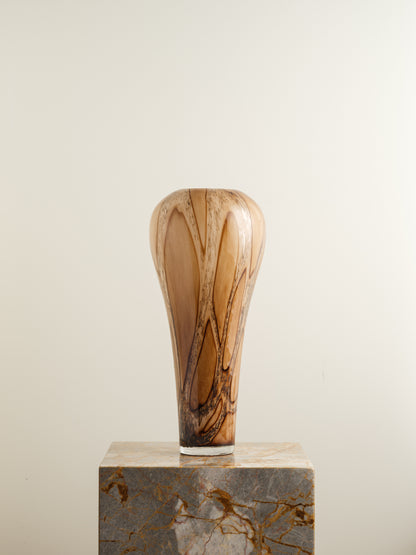 Tall fluted glass vase with caramel and brown marbled driftwood pattern.