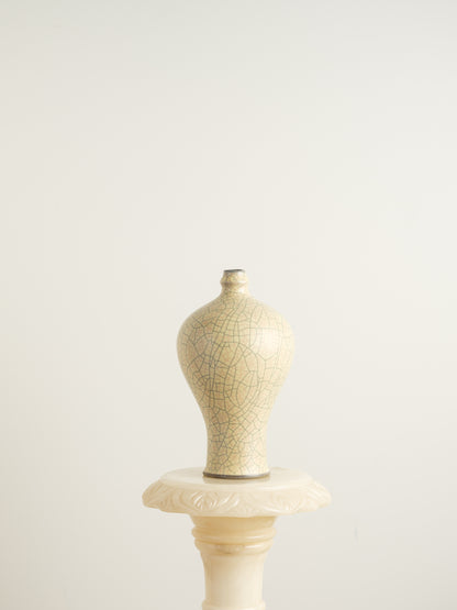 Celadon Crackle Meiping Vase, a traditional ceramic vessel with elegant curves and fine crackle glaze pattern, displayed on a pedestal.