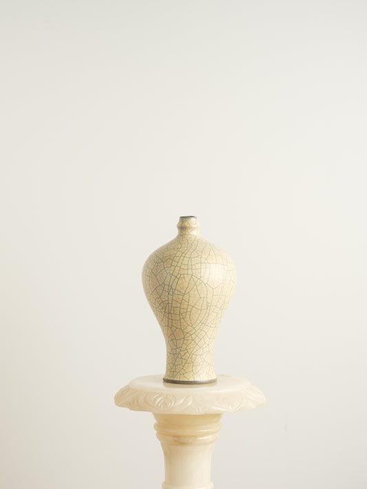 Celadon Crackle Meiping Vase, a traditional ceramic vessel with elegant curves and fine crackle glaze pattern, displayed on a pedestal.
