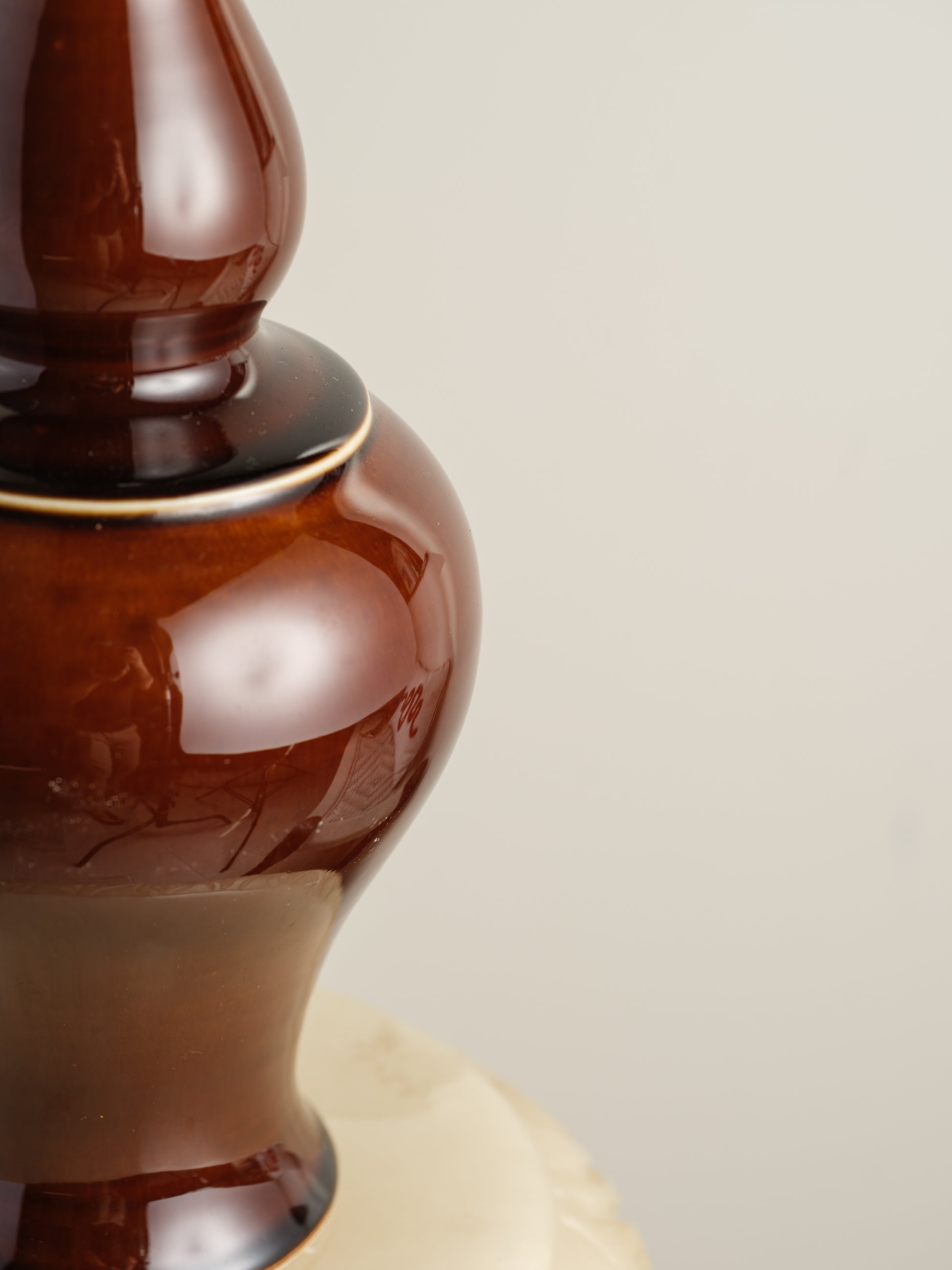 Ceramic meiping vase titled Chestnut Gloss, featuring a rich deep-brown glaze with a smooth reflective finish and elegant flared rim.
