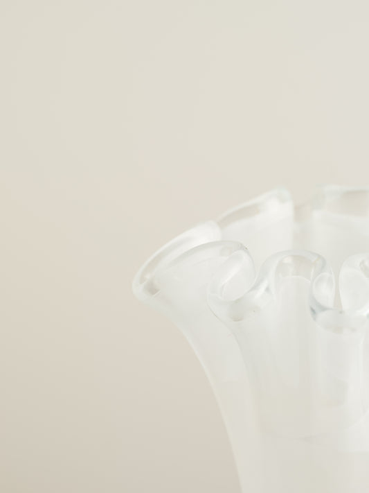 White opaline glass vase with softly ruffled petal rim and cloud-like translucence.
