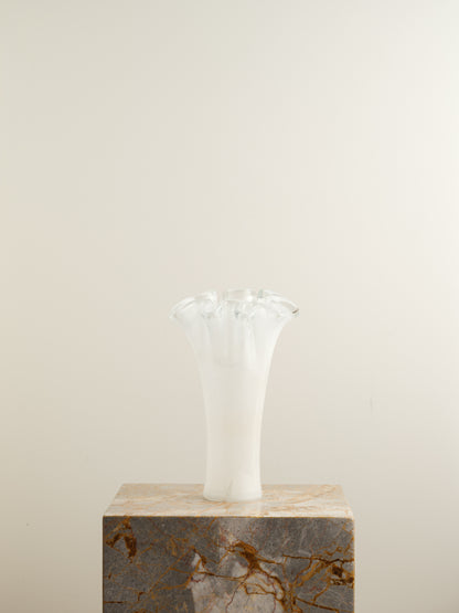 White opaline glass vase with softly ruffled petal rim and cloud-like translucence.
