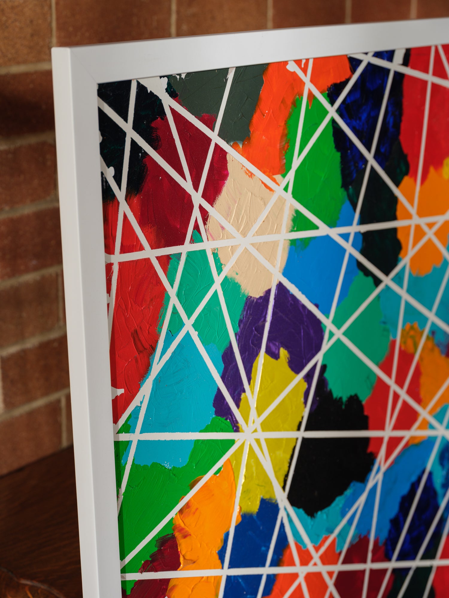 Abstract acrylic painting titled Constellations of Color, featuring vibrant patches of bold hues intersected with geometric white lines.