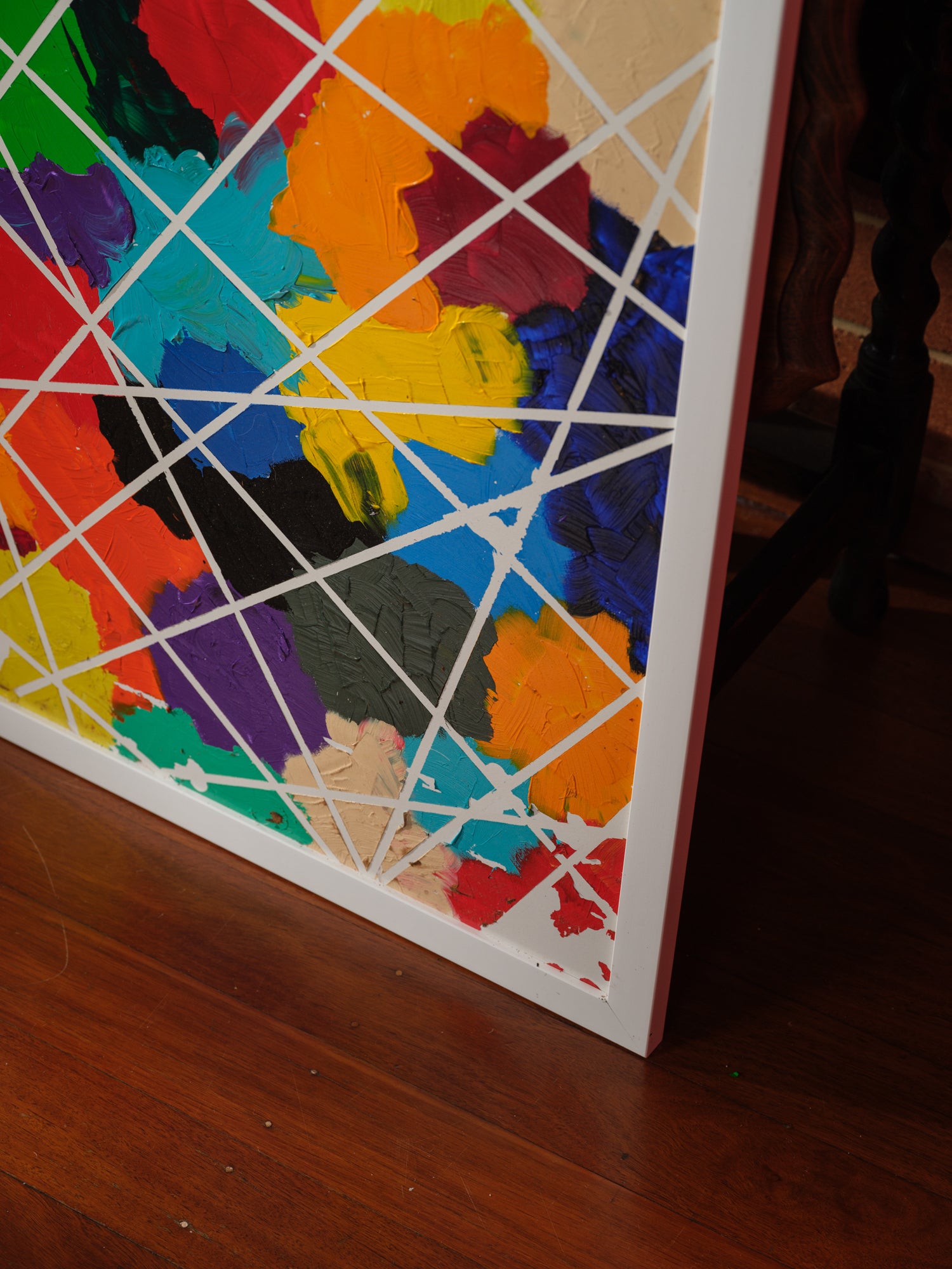 Abstract acrylic painting titled Constellations of Color, featuring vibrant patches of bold hues intersected with geometric white lines.