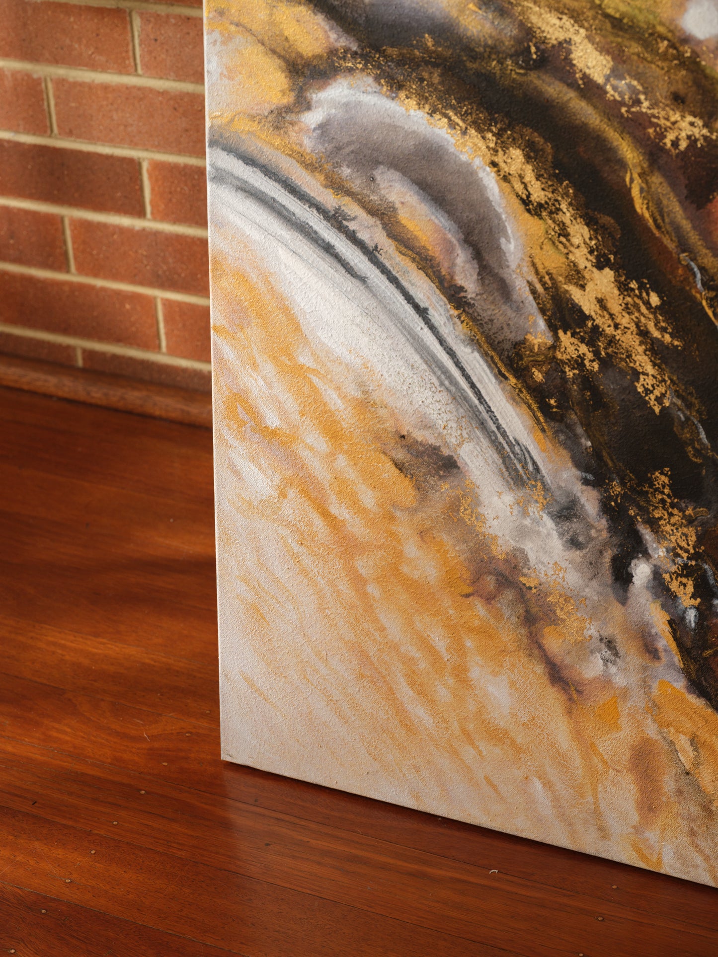Abstract acrylic painting titled Ember Current, featuring dynamic swirls of gold, black, white, and fiery orange tones.