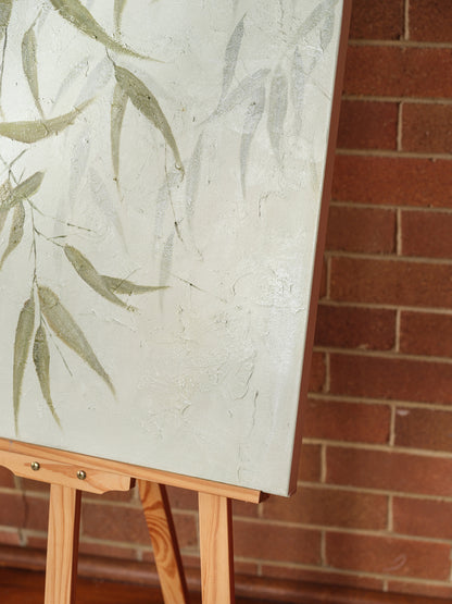 Abstract painting titled Eucalypt Reverie, featuring green eucalyptus leaves with soft brushstrokes on a light canvas background.