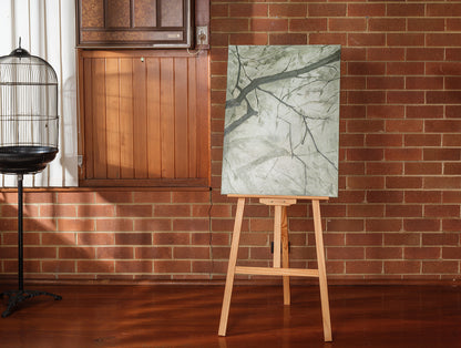Abstract painting titled Frosted Lines, featuring cool grey and white tones with branch-like linear patterns on canvas.