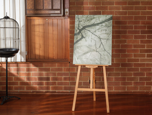 Abstract painting titled Frosted Lines, featuring cool grey and white tones with branch-like linear patterns on canvas.