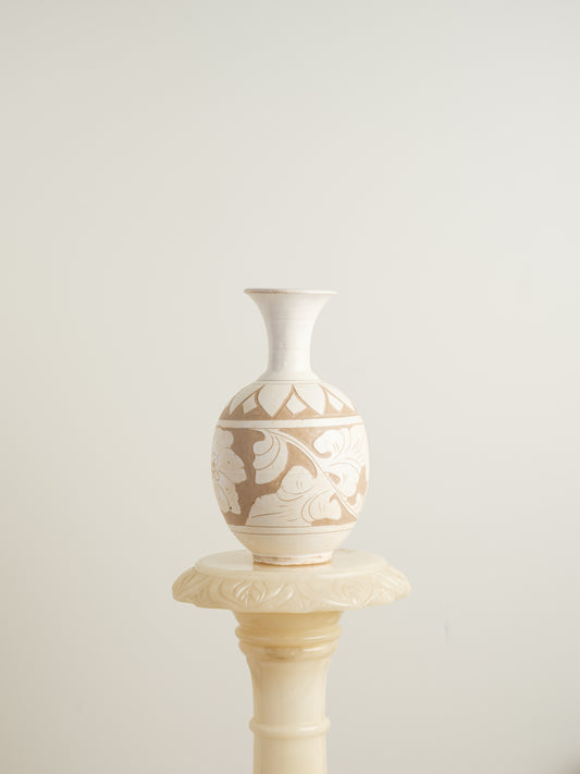 Ivory Blossom Sgraffito Vase, featuring hand-carved floral motifs in contrasting ivory and earthy tones with a traditional rounded body and flared neck.