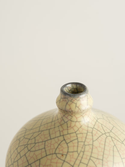 Celadon Crackle Meiping Vase, a traditional ceramic vessel with elegant curves and fine crackle glaze pattern, displayed on a pedestal.
