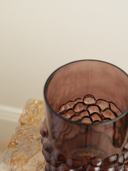 Deep plum-coloured glass vase with cylindrical form and raised hobnail texture around the middle.