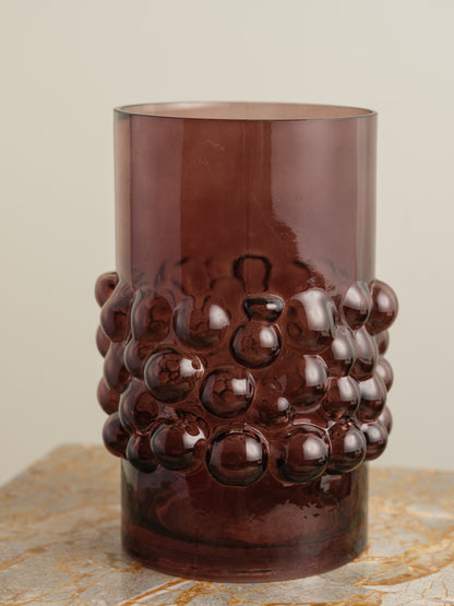 Deep plum-coloured glass vase with cylindrical form and raised hobnail texture around the middle.
