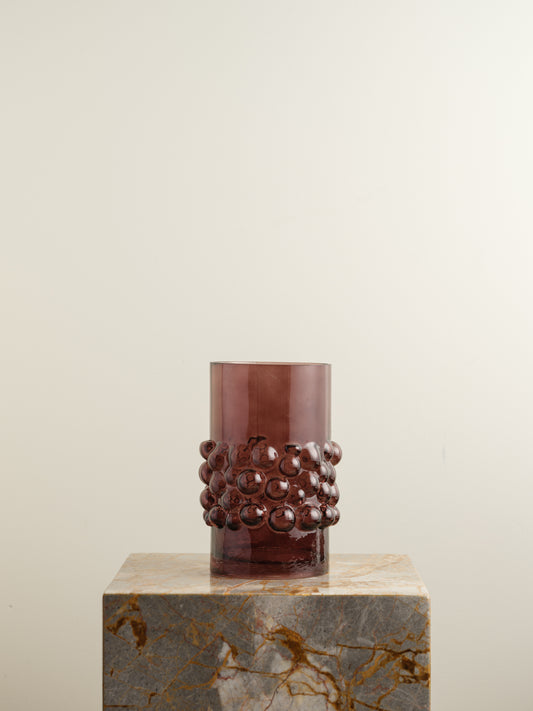 Deep plum-coloured glass vase with cylindrical form and raised hobnail texture around the middle.