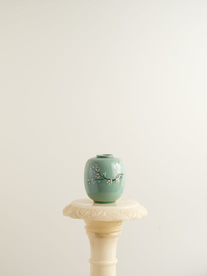 Petite celadon jar with fine crackle glaze, hand-painted plum blossoms and a sparrow motif.