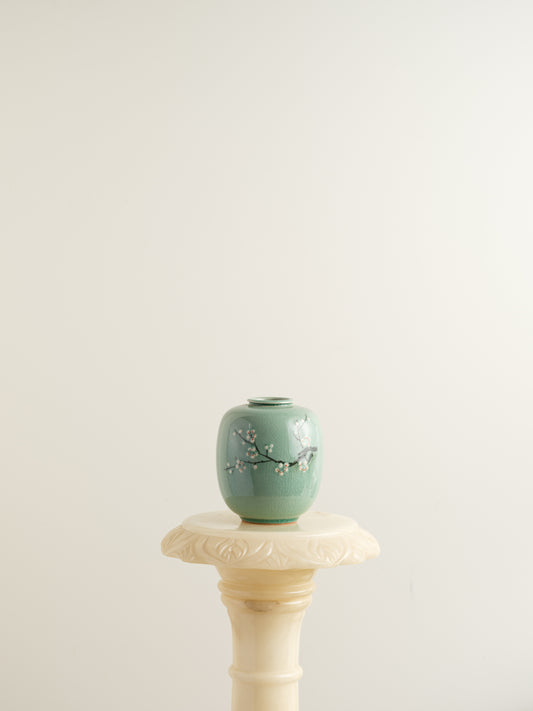 Petite celadon jar with fine crackle glaze, hand-painted plum blossoms and a sparrow motif.