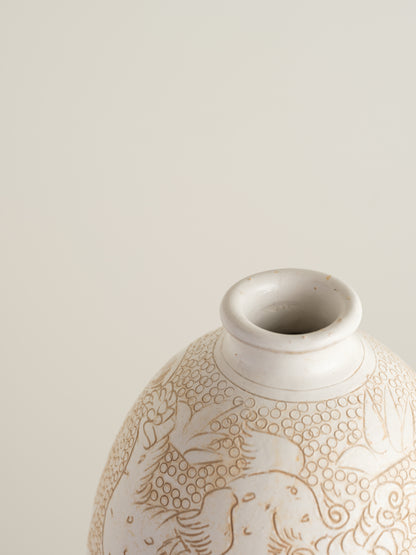 Sgraffito ceramic vase titled Qilin Whisper, featuring an ivory surface etched with a mythological qilin design in soft beige tones.