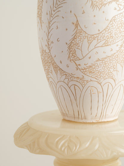 Sgraffito ceramic vase titled Qilin Whisper, featuring an ivory surface etched with a mythological qilin design in soft beige tones.