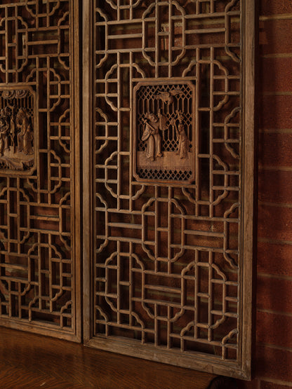 Pair of antique Chinese lattice panels with intricate geometric fretwork and carved scholar scenes in relief at the center.