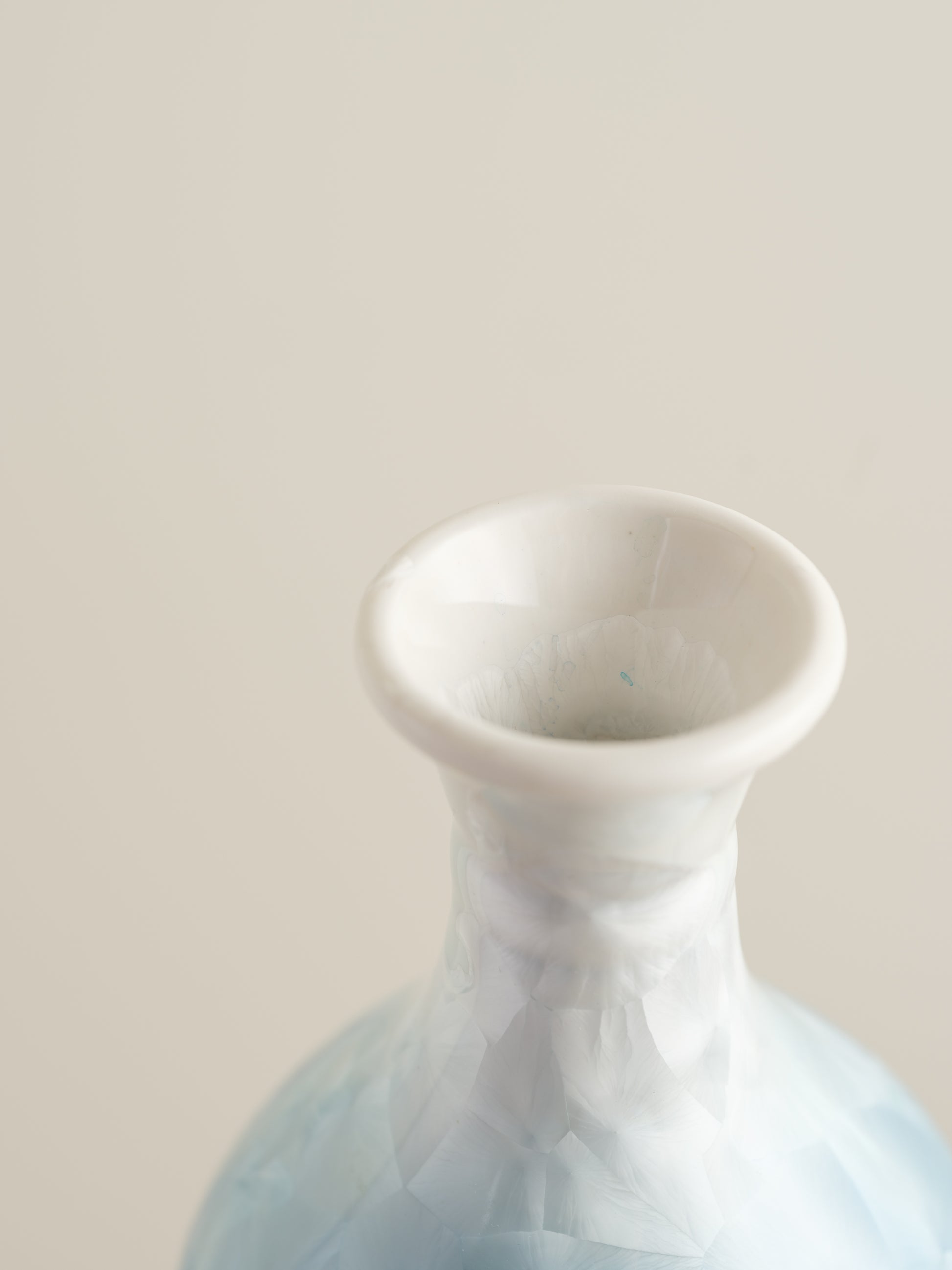 Porcelain vase in gradient white to aqua blue with crystalline bloom patterns on the surface.