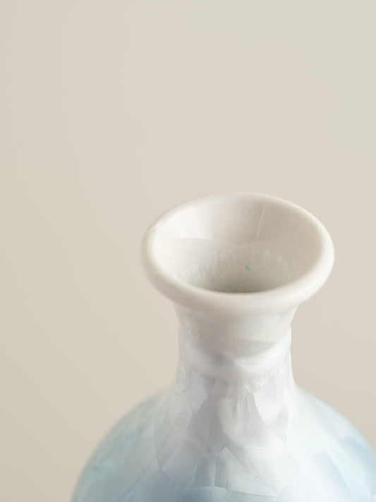 Porcelain vase in gradient white to aqua blue with crystalline bloom patterns on the surface.
