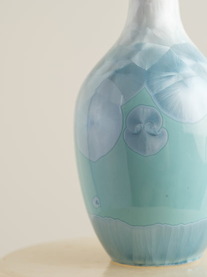 Porcelain vase in gradient white to aqua blue with crystalline bloom patterns on the surface.