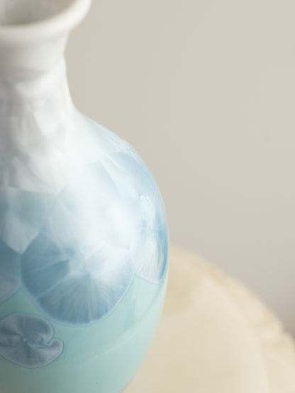 Porcelain vase in gradient white to aqua blue with crystalline bloom patterns on the surface.