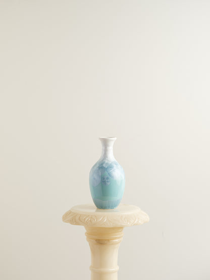 Porcelain vase in gradient white to aqua blue with crystalline bloom patterns on the surface.