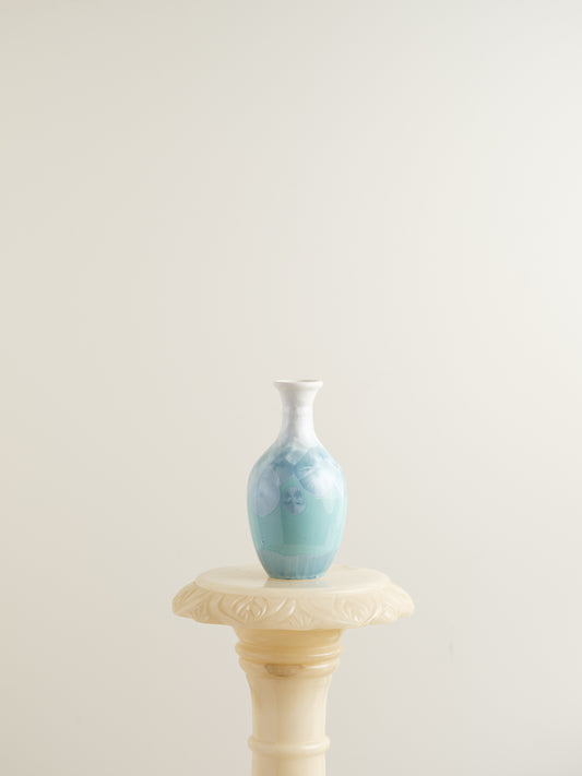 Porcelain vase in gradient white to aqua blue with crystalline bloom patterns on the surface.