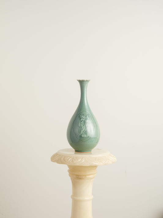Song Whisper Celadon Vase, a delicate ceramic vessel with a slender flared neck and subtle engraved figure motif on a pale green glaze.