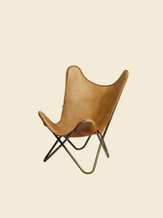 Tan suede butterfly lounge chair with stitched leather seat and metal frame, mid-century modern style