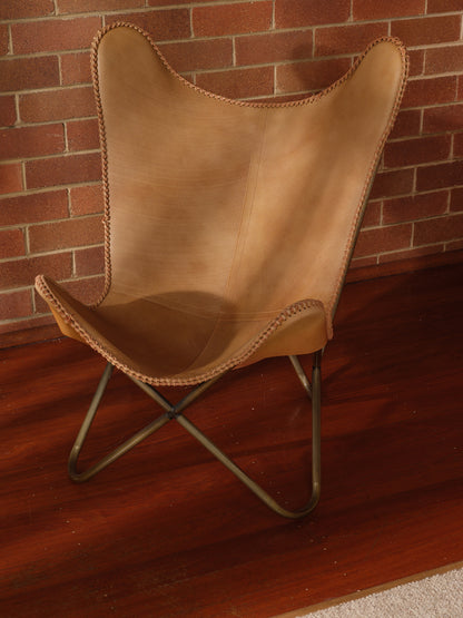 Tan suede butterfly lounge chair with stitched leather seat and metal frame, mid-century modern style
