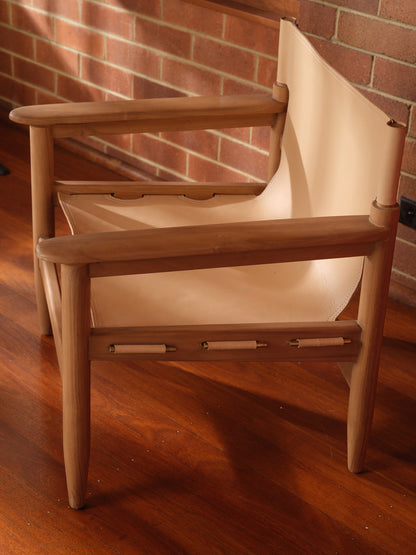 Tanned leather armchair with natural wood frame, modern accent seating