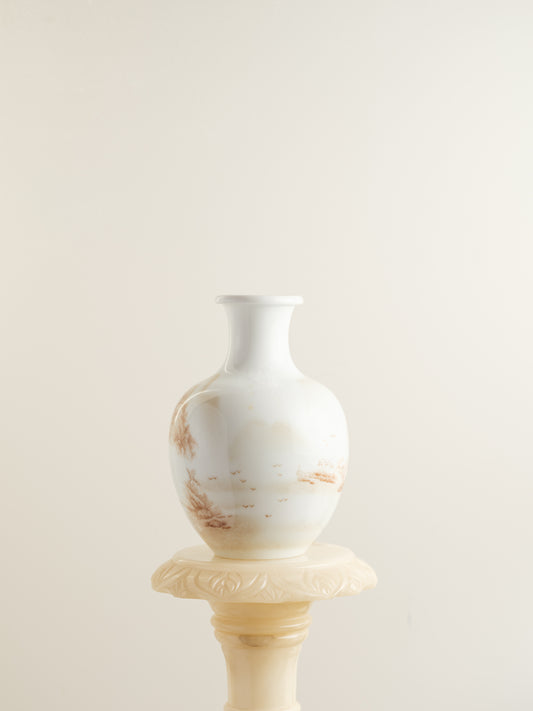 Porcelain vase with tea-wash glaze and hand-painted sepia landscape scene of mountains and flying birds.