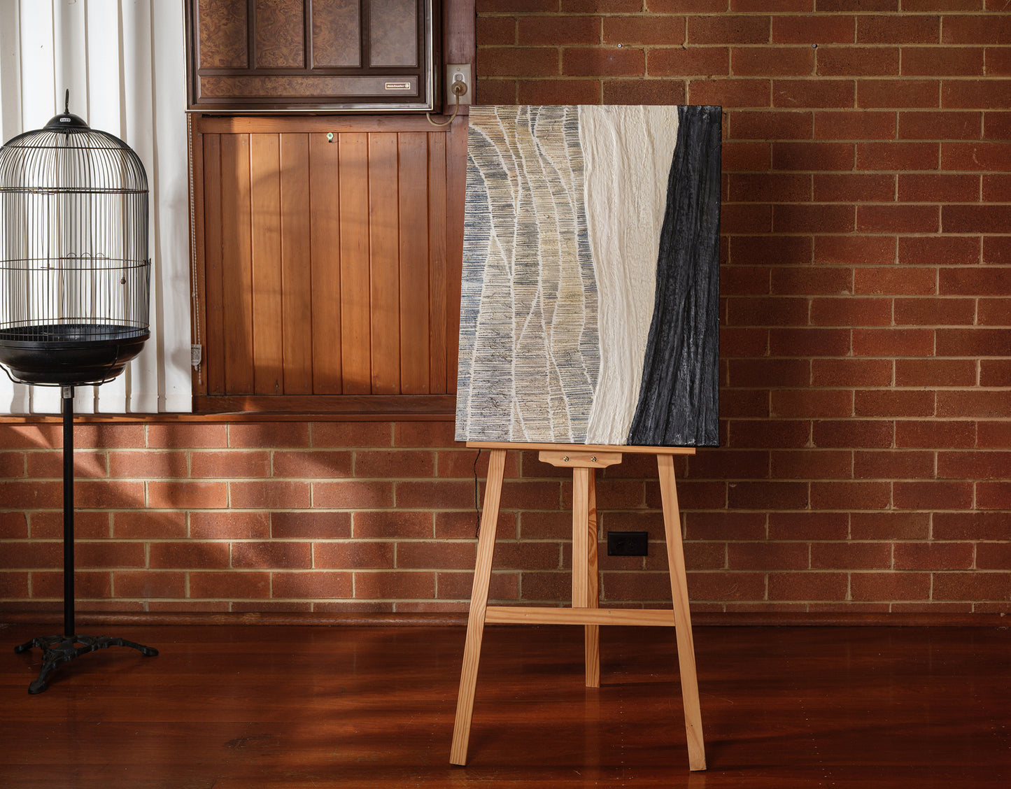 Abstract textured painting titled Tidal Strata I, featuring layered vertical bands in beige, cream, and charcoal tones on canvas.