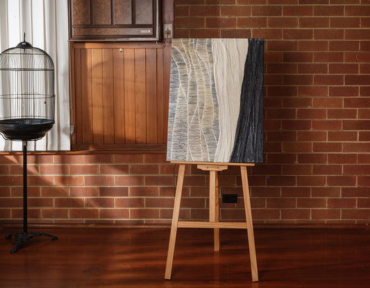 Abstract textured painting titled Tidal Strata I, featuring layered vertical bands in beige, cream, and charcoal tones on canvas.