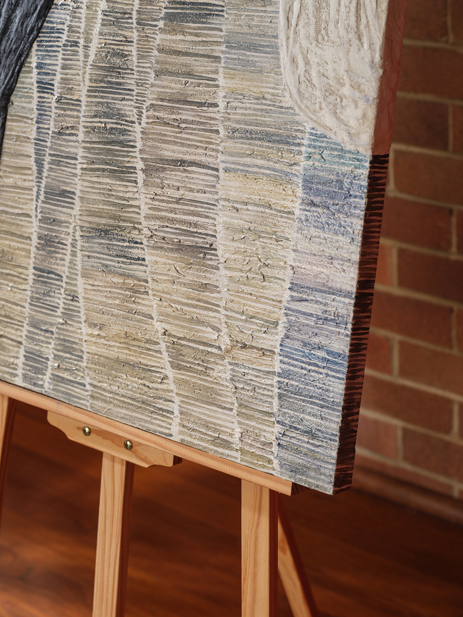 Abstract textured painting titled Tidal Strata II, featuring layered vertical bands in cream, beige, and charcoal tones on canvas.