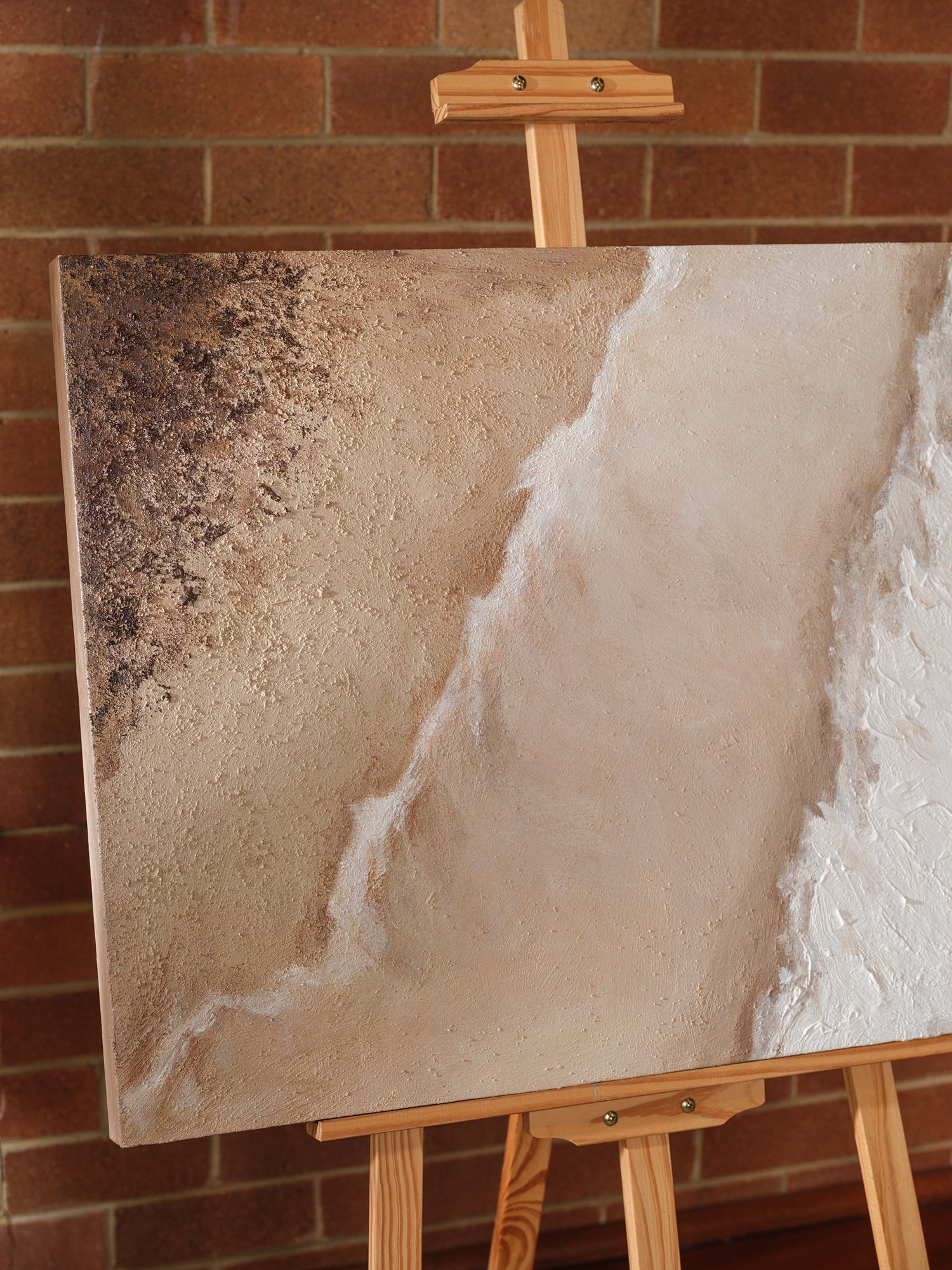 Abstract textured painting titled Tideworn Dune, featuring layered sandy beige and white tones evoking coastal dunes on canvas.