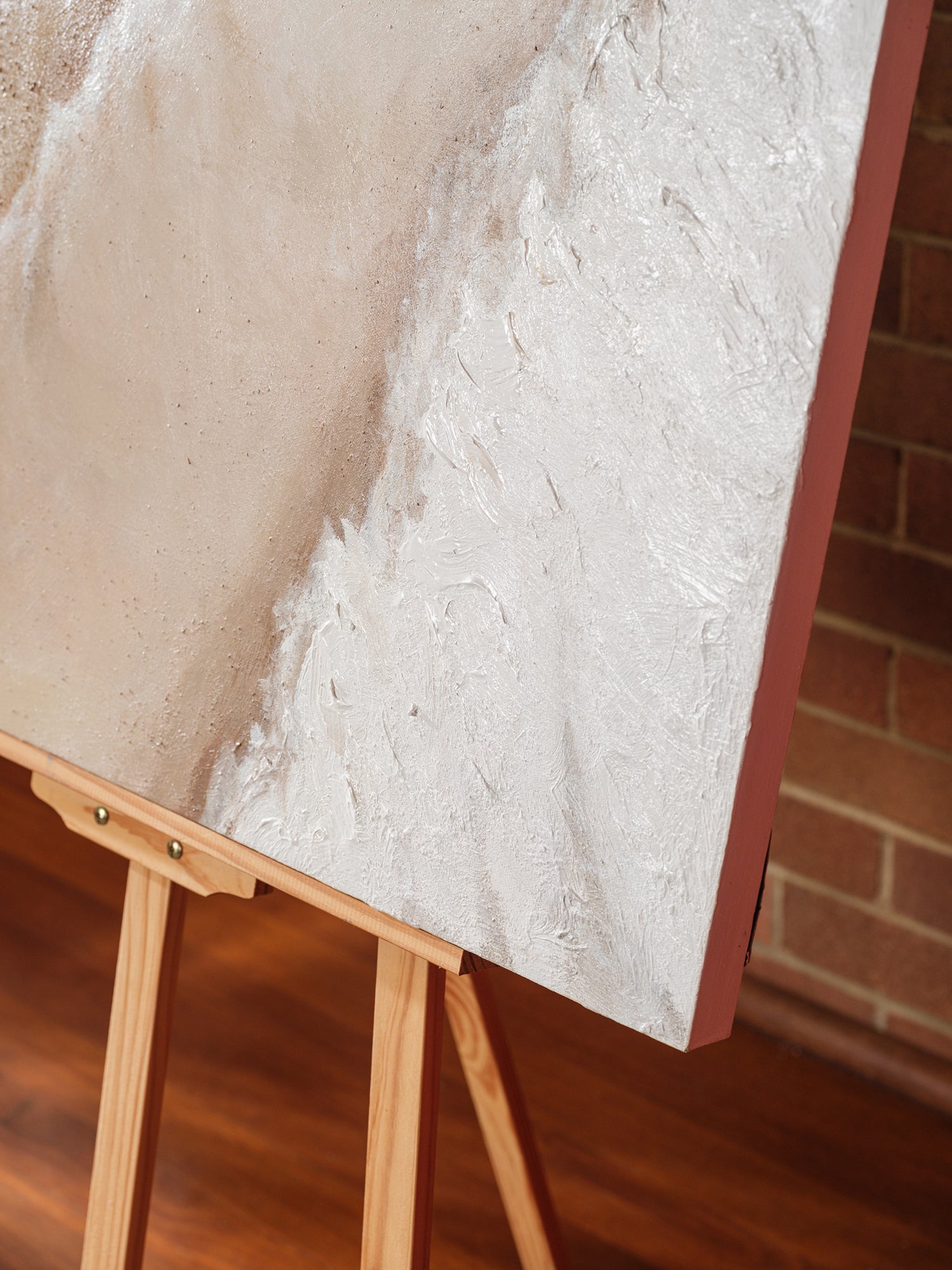 Abstract textured painting titled Tideworn Dune, featuring layered sandy beige and white tones evoking coastal dunes on canvas.
