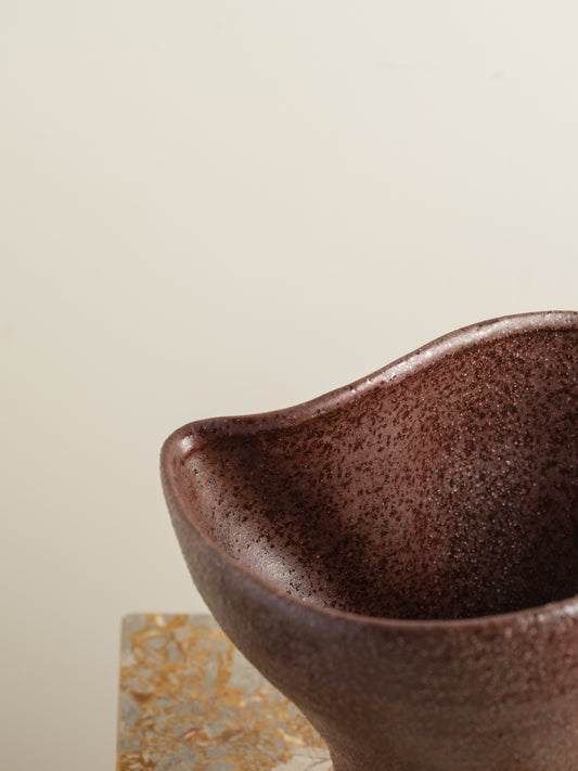 Hand-thrown brown stoneware vase with textured matte glaze and flared crest rim.
