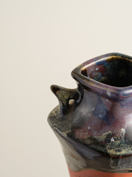 Vermilion Storyteller Relief Vase featuring hand-applied figurative relief on a tall form with dark glaze accents.